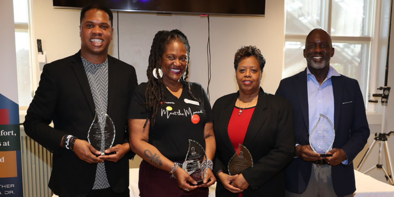 Mychal Bacoate, Nicole Cush, Priscilla Robinson, and D. Tyrell McGirt holding awards