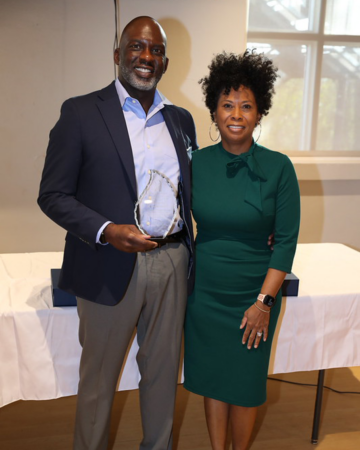 D. Tyrell McGirt standing with his wife holding award