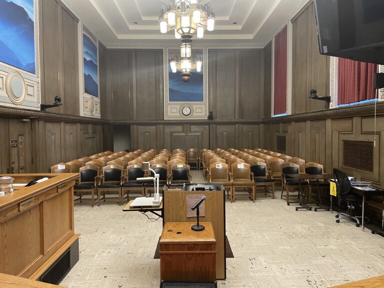 Shot looking back at empty audience seats in council chamber