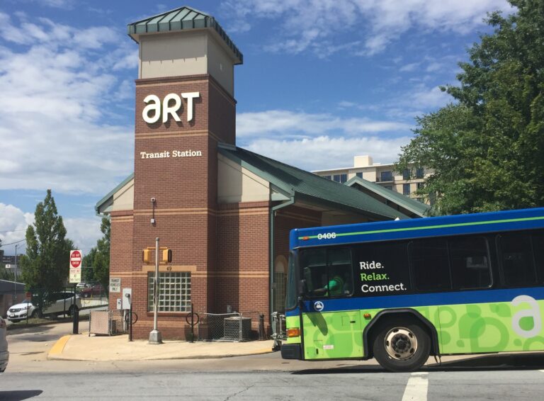 Art bus pulling away from downtown transit center