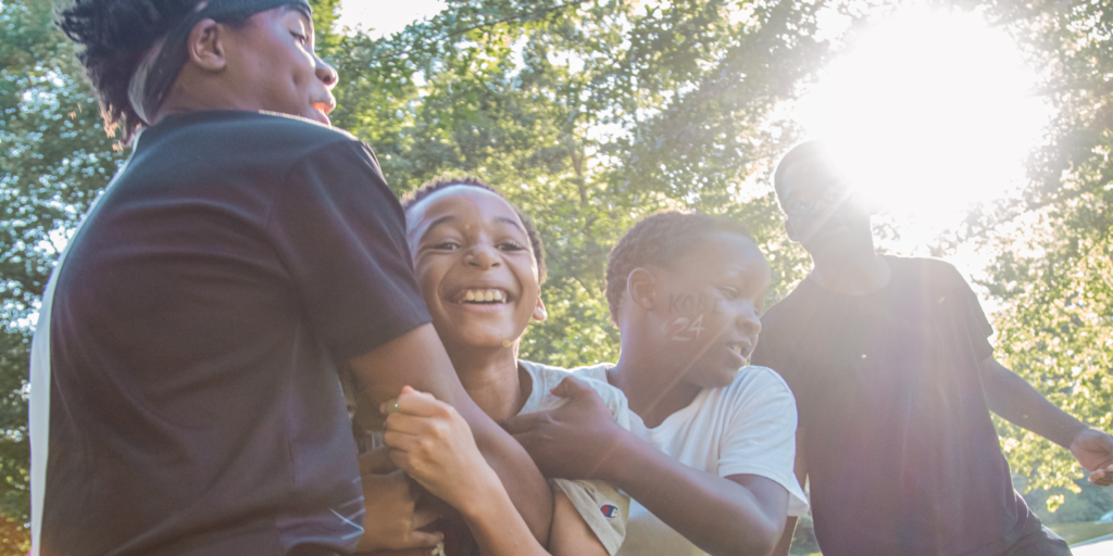 four kids playing football
