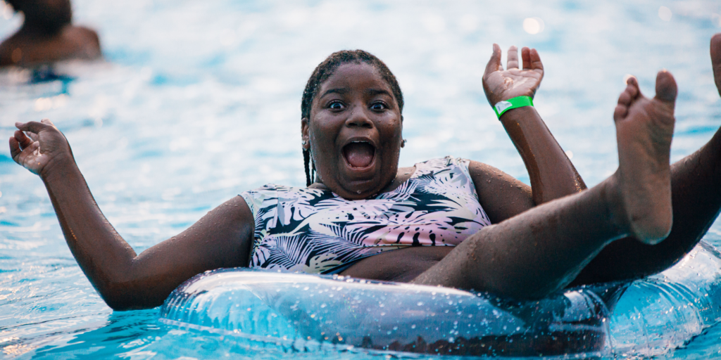 teen floating in inner tube in a pool