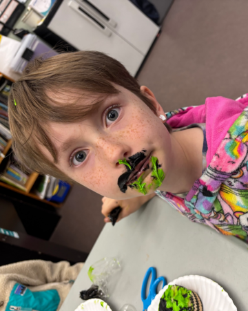 young artist gladys with frosting on face