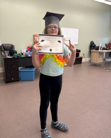 young artist mabel holding a certificate