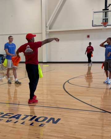 DeVonte leading a team building activity in a gym