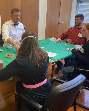 dealer and players at casino table