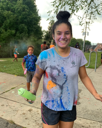teen wearing a shirt covered with paint