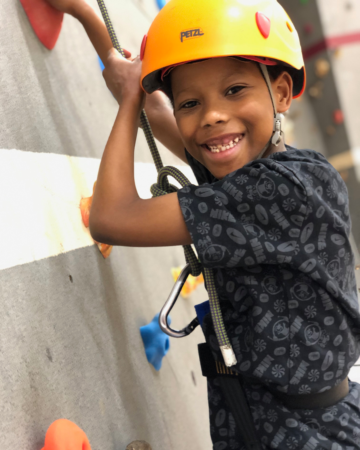 kid on an indoor climbing wall