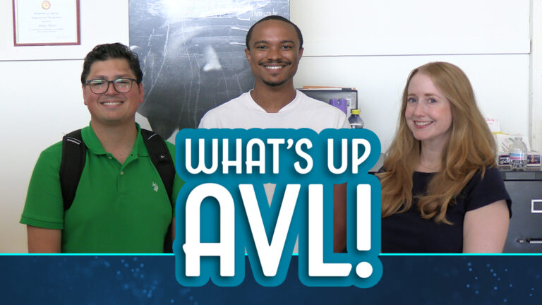 Cahries Rey and Rebecca smile at camera with Text What's Up AVL Superimposed over lower half of photo