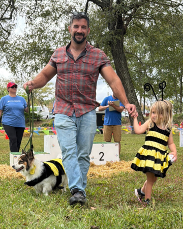 parent with dog and child in costumes