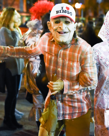 adult in a costume with a hat that reads i love bingo