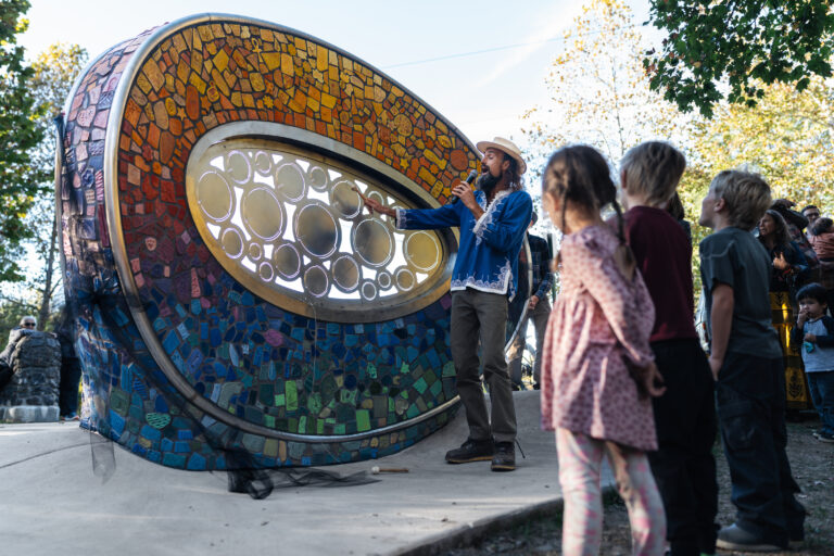 Local musician and kids enjoy new piece of public art.